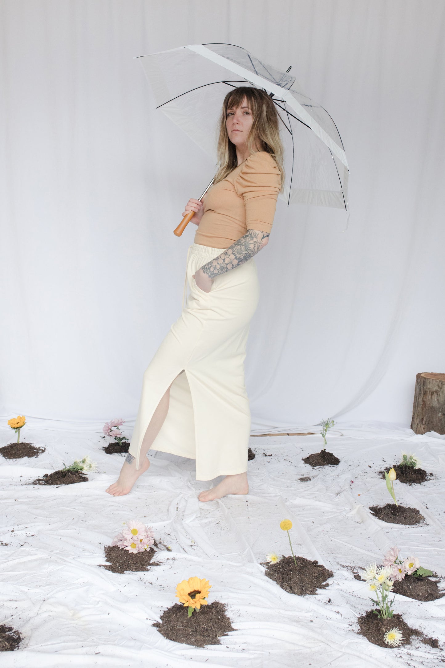 Image of model in skirt holding umbrella