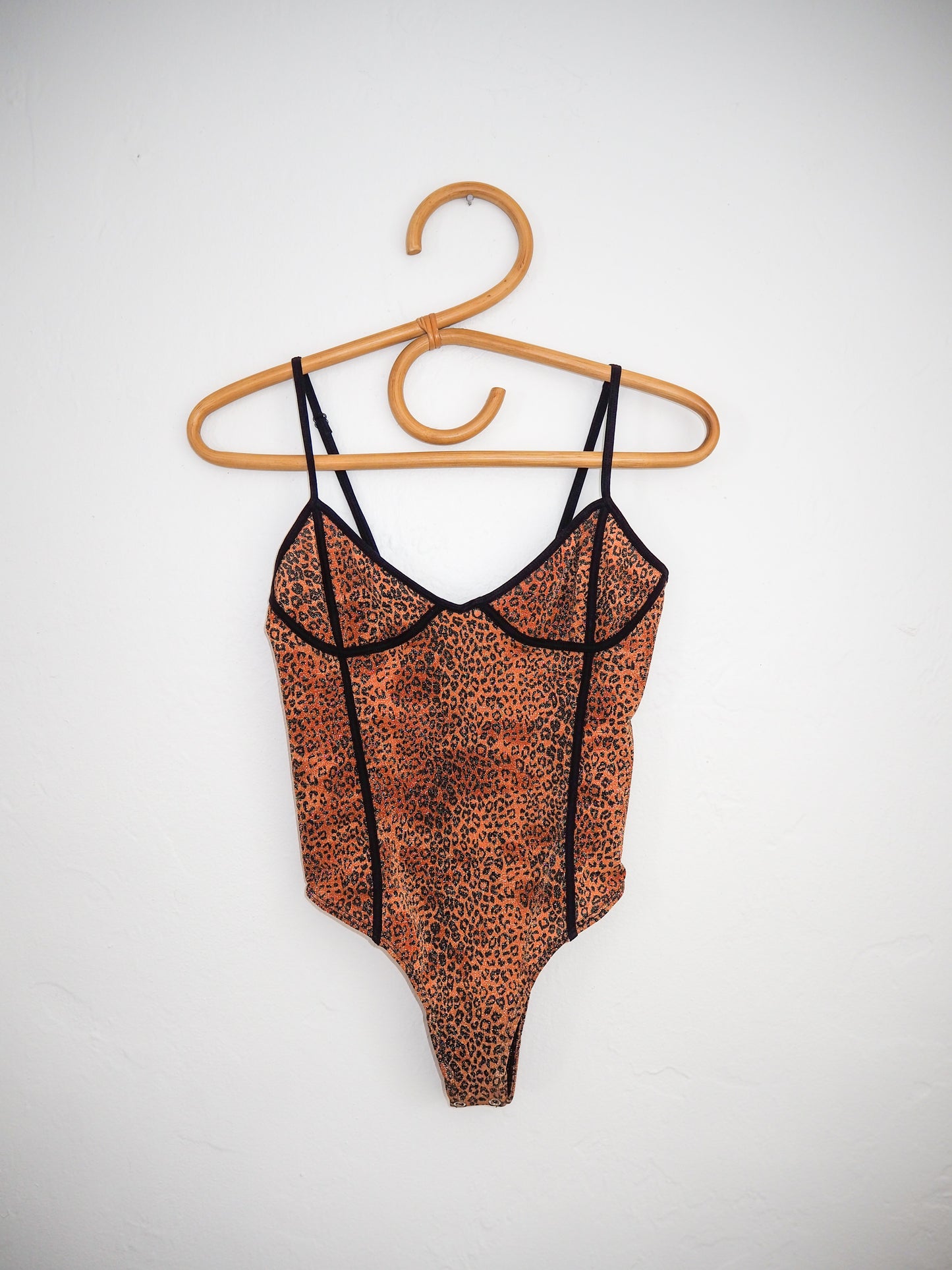 image of cala leopard bodysuit on hanger