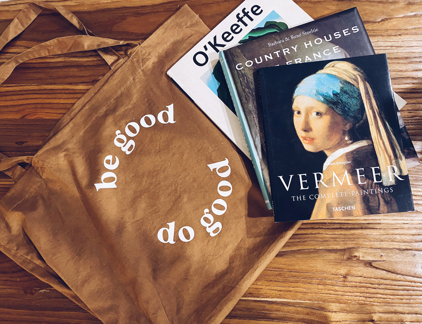 be good do good tote bag next to art books