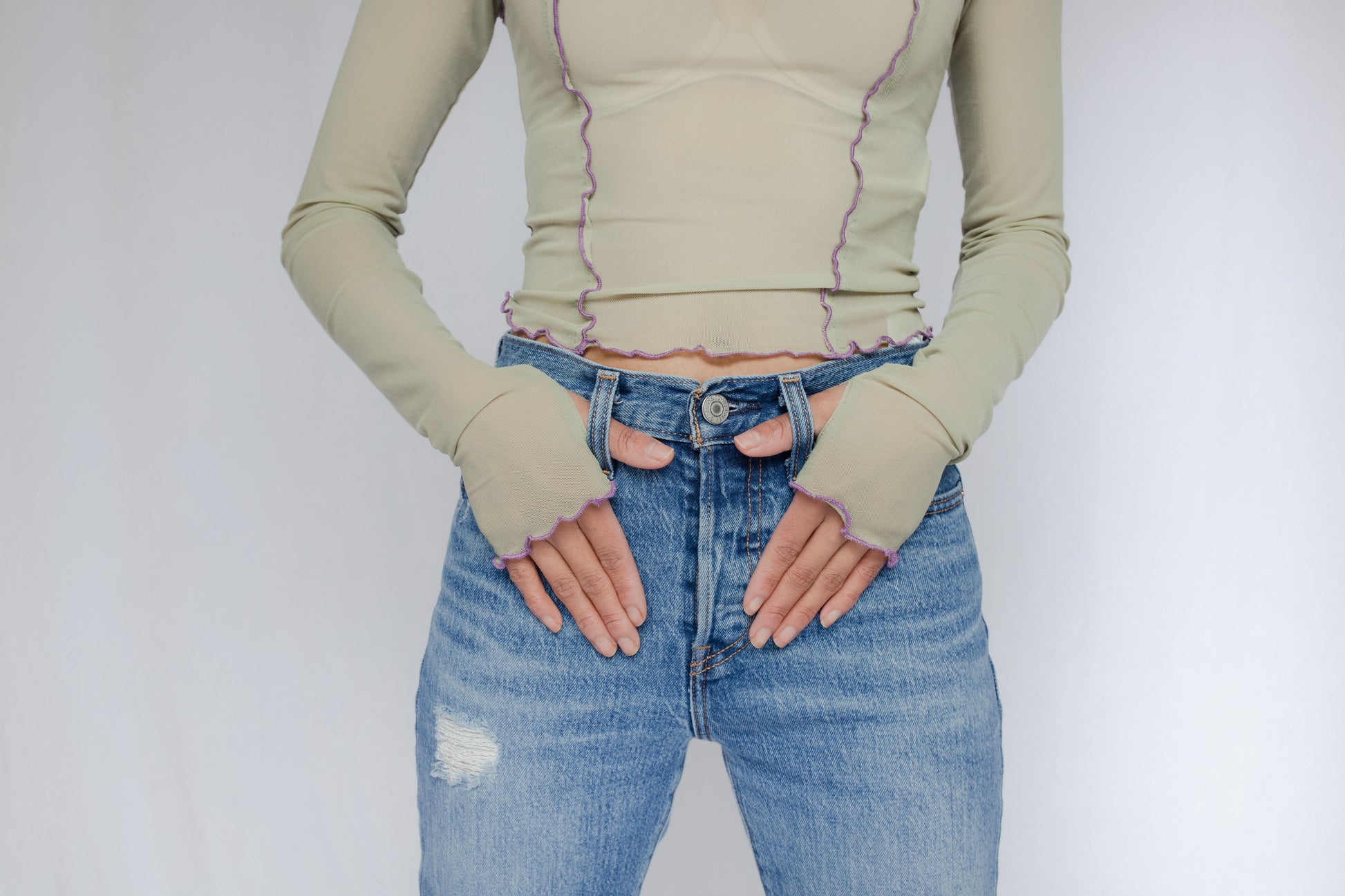 image of model in wavy hem mesh top