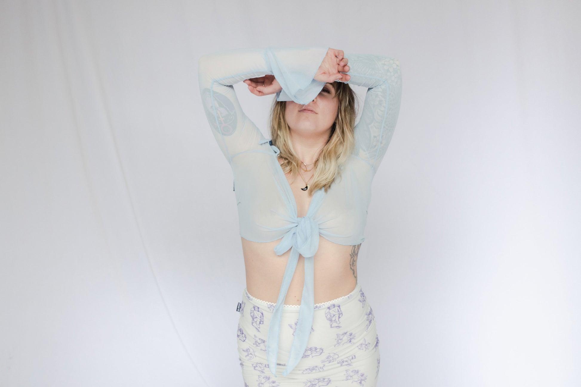 image of model in mesh tie up cardigan