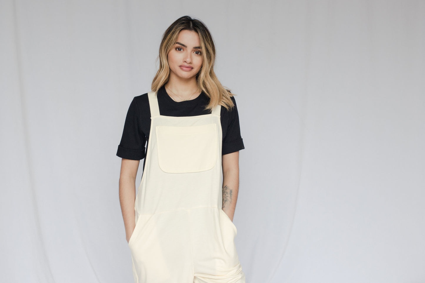 Image of model in overalls & tee