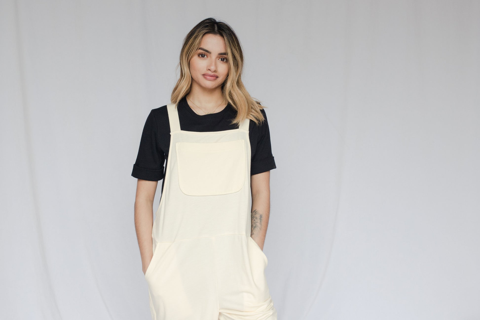Image of model in overalls & tee