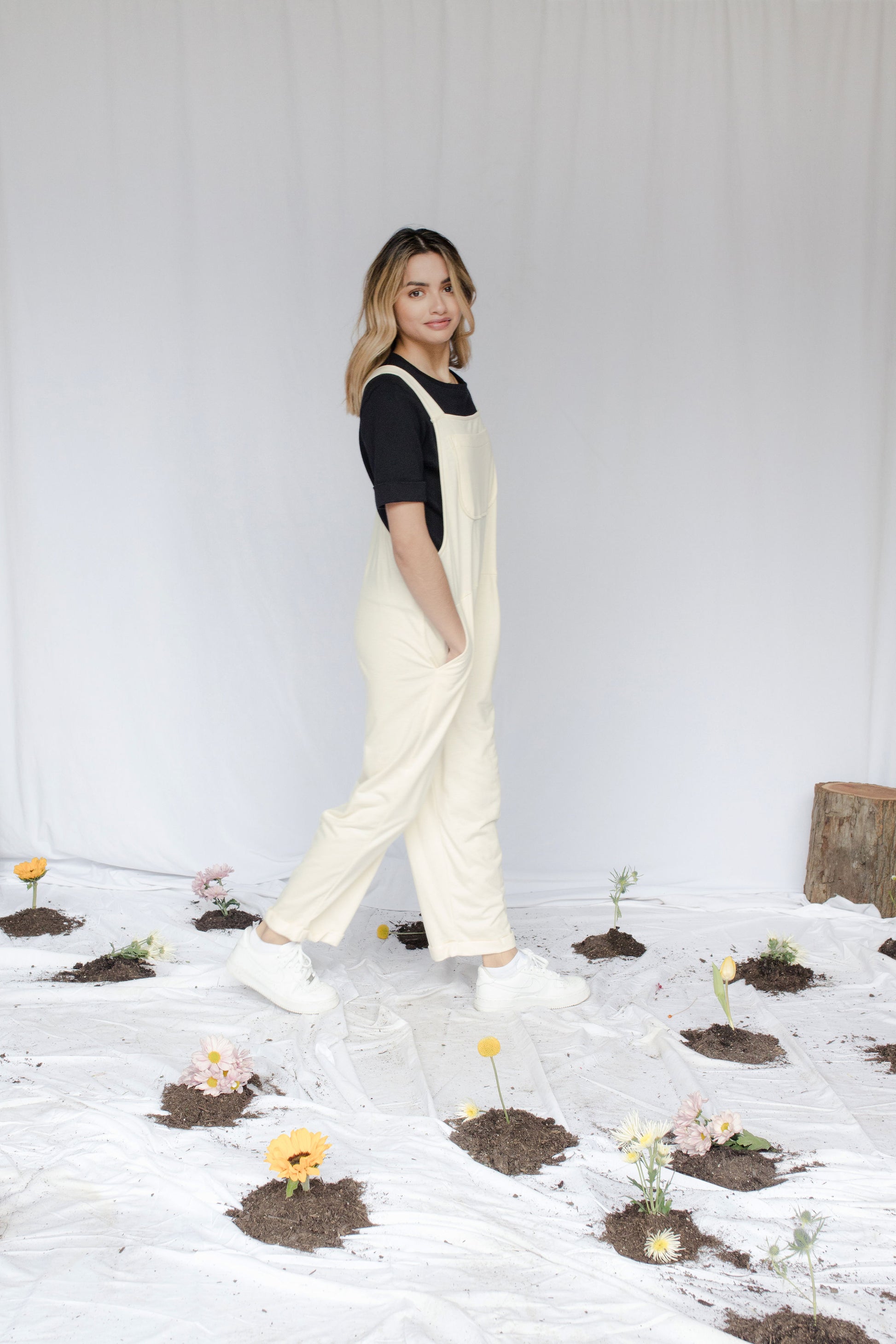 Image of model in overalls & tee