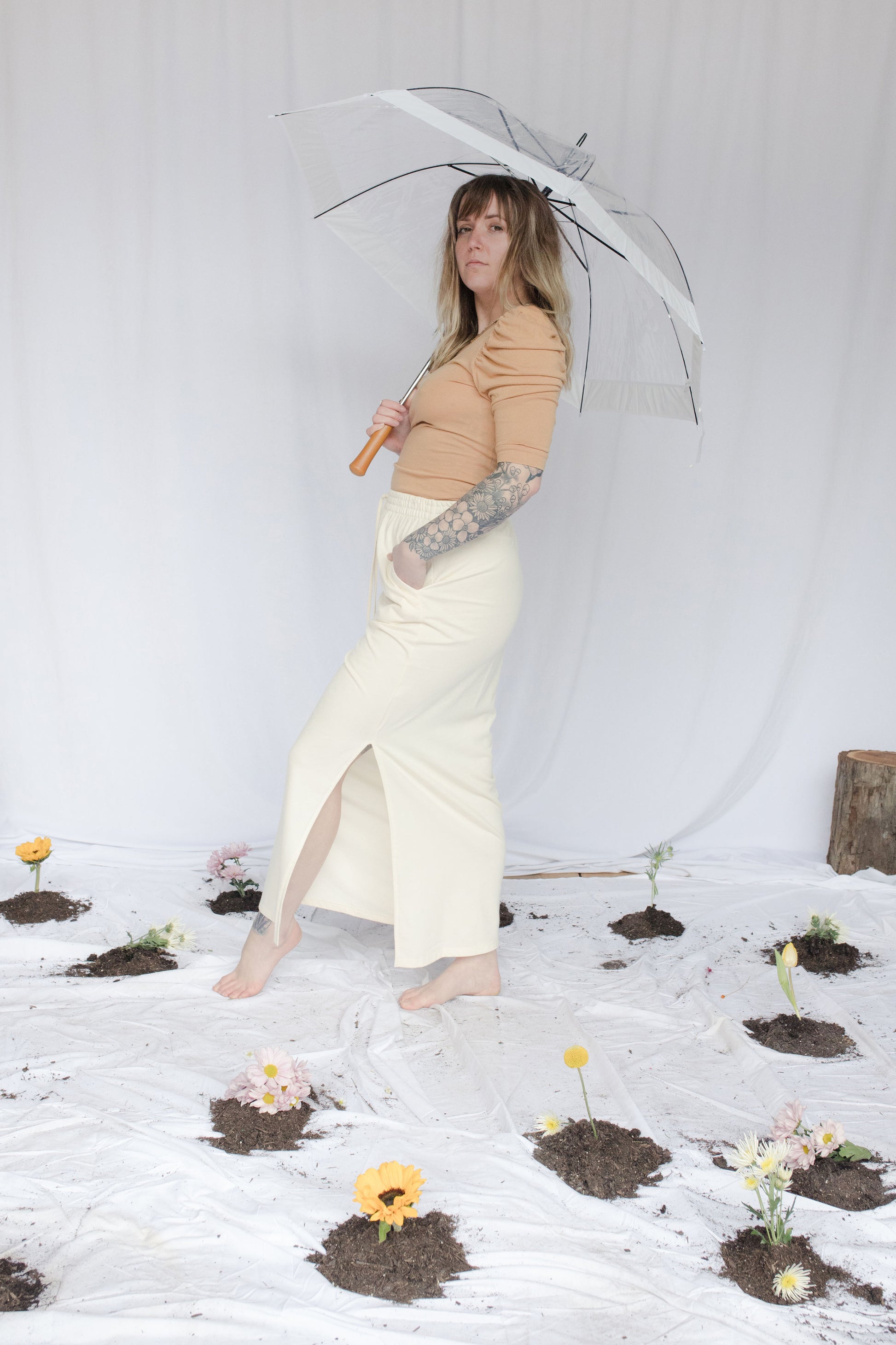 Image of model in skirt holding umbrella