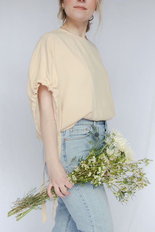 image of model wearing short tie sleeve blouse.