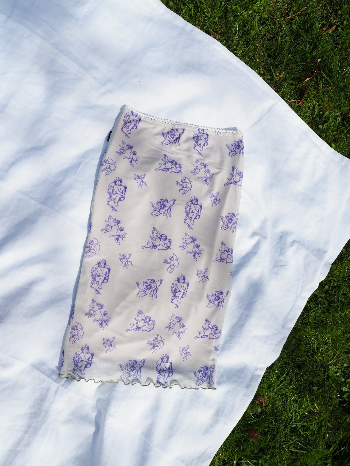 flatlay image of blue cupid midi lettuce skirt