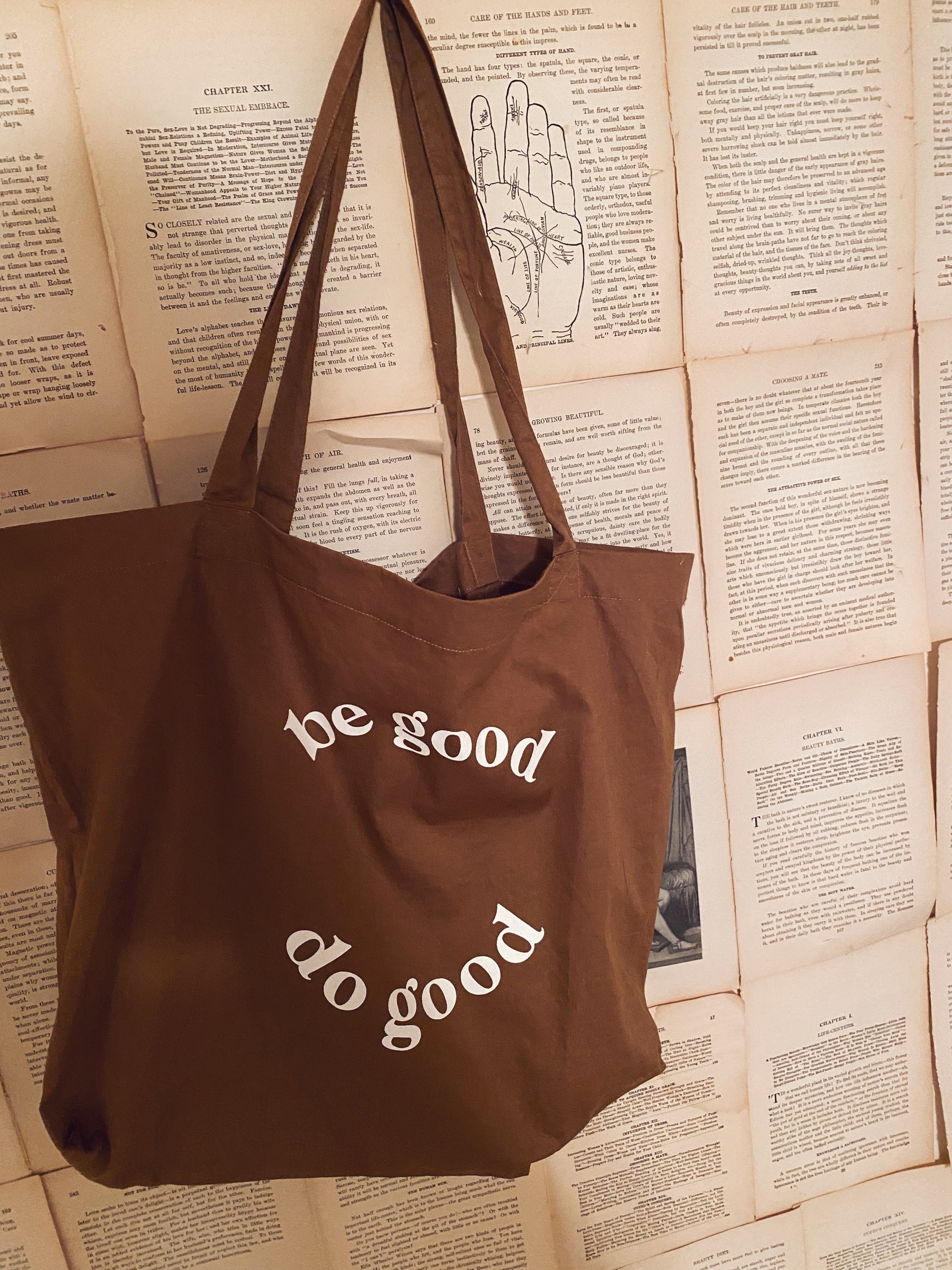be good do good tote bag hanging on wall 