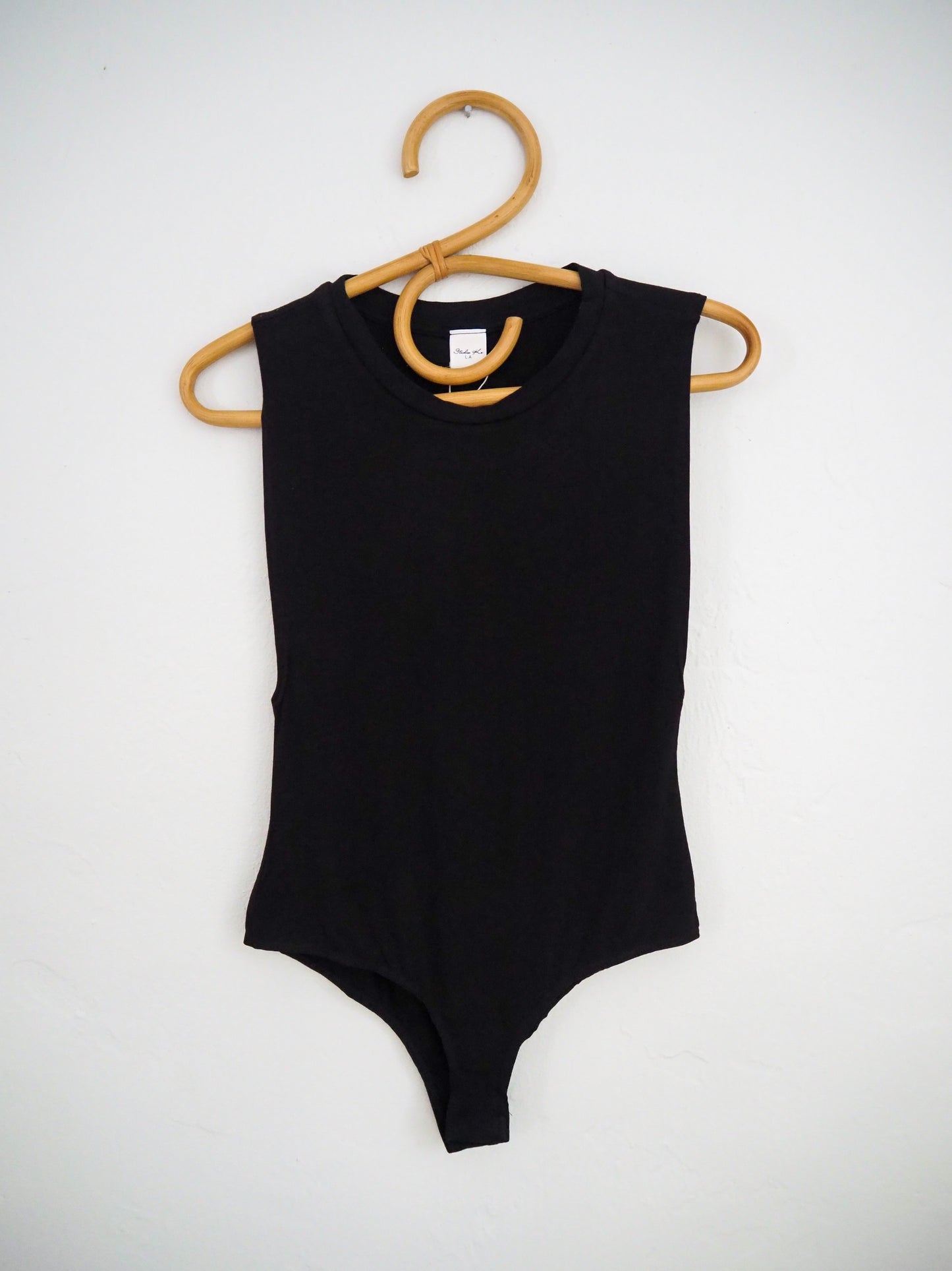 image of muscle tank bodysuit on hanger 